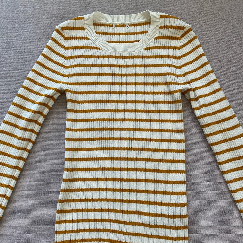 Mustard yellow striped and white ribbed knit top.